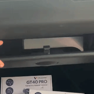 GT40 Pro vacuuming crumbs off a car seat, then cleaning out a glovebox