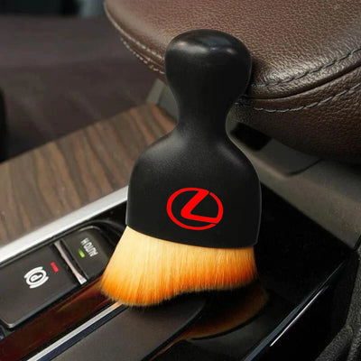 DustMate car detailing brush with the Lexus logo engraved on the handle, next to a car seat