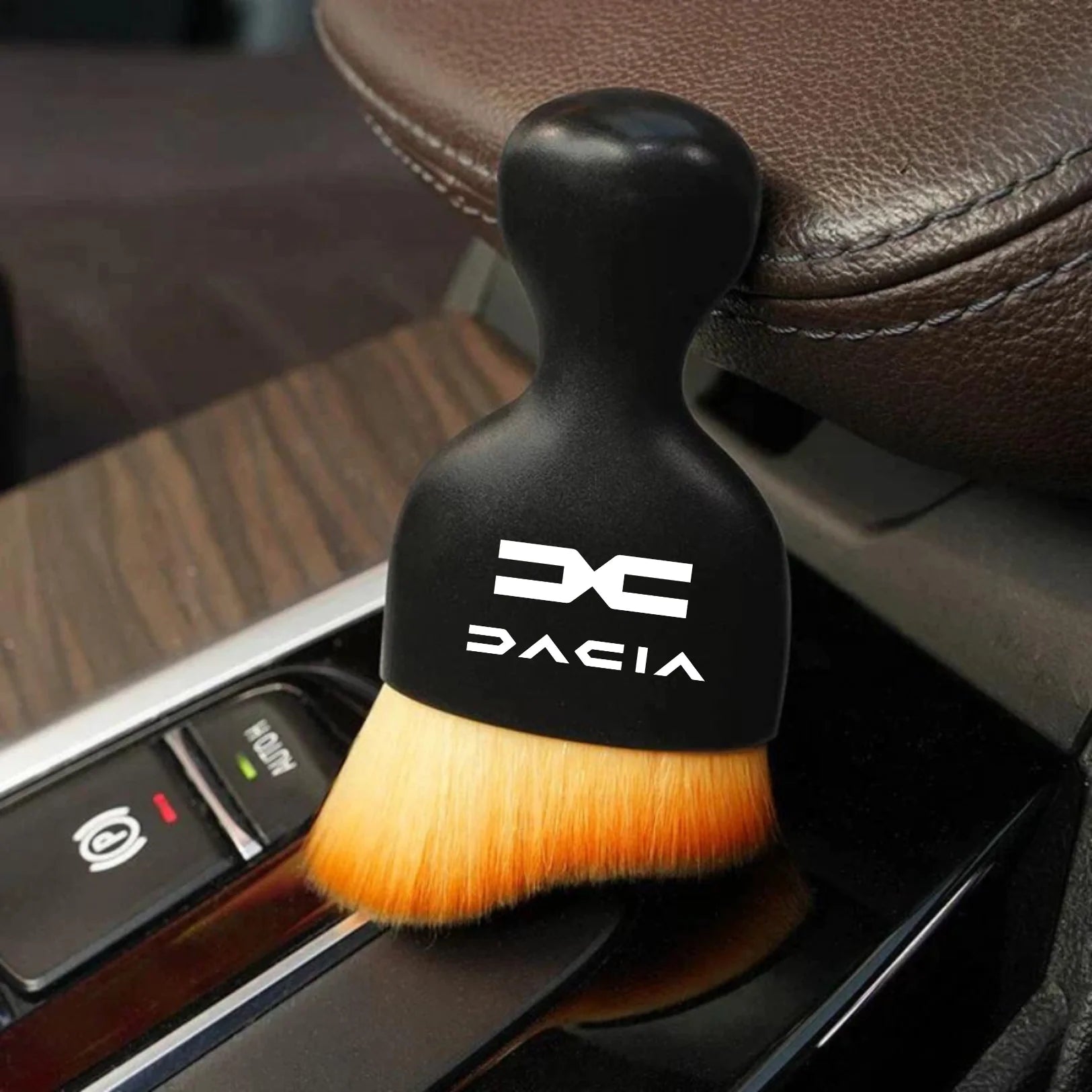 DustMate car detailing brush with the new Dacia logo engraved on the handle, next to a car seat