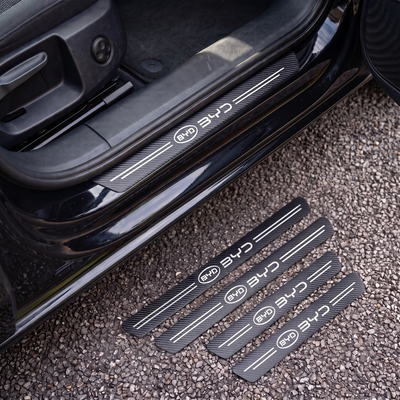 CarbonGrip PRO door sill protectors with BYD logo: one fitted on the sill, set of 4 on the ground