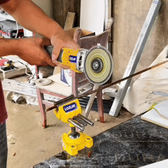 Angle grinder with a DiscMate diamond cutting disc cutting a steel rod held in a vice, then a white board