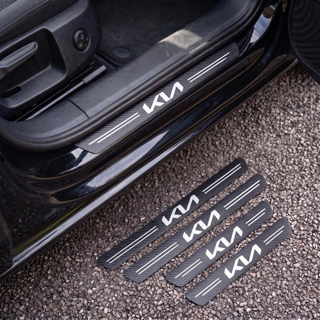 CarbonGrip PRO door sill protectors with new Kia logo: one fitted on the sill, set of 4 on the ground