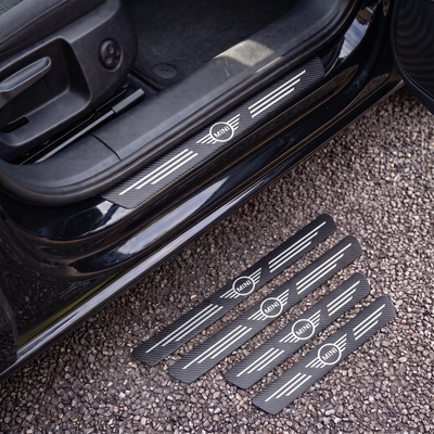 CarbonGrip PRO door sill protectors with Mini logo: one fitted on the sill, set of 4 on the ground